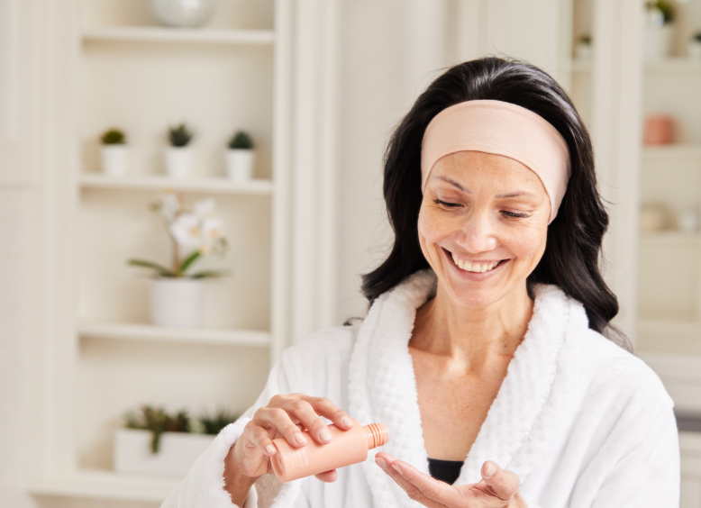 Woman using RENU Advanced Skin Care by ASEA