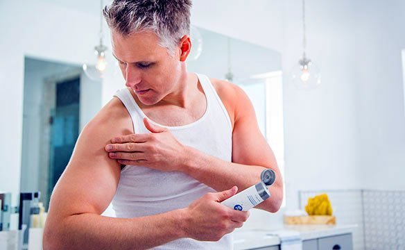 Middle-aged man applying ASEA Renu 28 to his arms