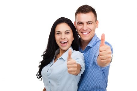 Young couple giving thumbs-up